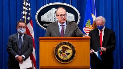 Jeff Clark, Assistant Attorney General for the Environment and Natural Resources Division, speaks as Deputy Attorney General Jeffrey Rosen, right, and Environmental Protection Agency (EPA) Administrator Andrew Wheeler, left, look on during a news conference at the Justice Department in Washington, Monday, Sept. 14, 2020. Automakers Daimler AG and subsidiary Mercedes-Benz USA have agreed to pay $1.5 billion to the U.S. government and California state regulators to resolve emissions cheating allegations.