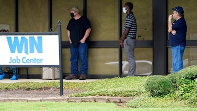 In this Aug. 31, 2020, file photo, clients line up outside the Mississippi Department of Employment Security WIN Job Center in Pearl, Miss. The government issues the jobs report Friday, Sept. 4, for August at a time of continuing layoffs and high unemployment.