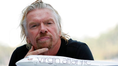 In this June 16. 2011, file photo, Richard Branson, president of Virgin Atlantic Airways, attends a news conference in Miami Beach, Fla. Branson announced that Virgin was starting flights between London and Cancun, Mexico. Virgin Atlantic, the airline founded by British businessman Branson, filed Tuesday, Aug. 4, 2020, for relief from creditors as the virus pandemic hammers the airline industry. The airline made the filing in U.S. federal bankruptcy court in New York after a proceeding in the United Kingdom.