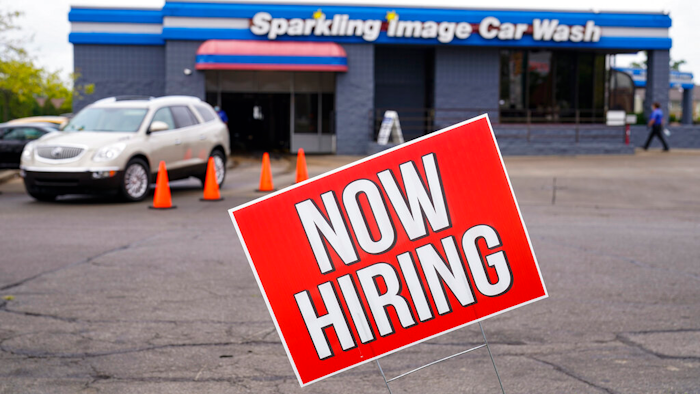 A help wanted sign is displayed at car wash in Indianapolis.