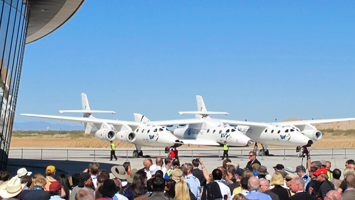 A crowd gathers outside Spaceport America for a dedication ceremony.