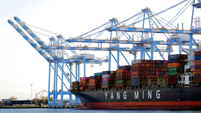 Cargo cranes are used to take containers off of a Yang Ming Marine Transport Corporation boat at the Port of Tacoma in Tacoma, Wash.