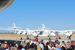 A crowd gathers outside Spaceport America for a dedication ceremony.
