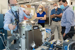 In this June 18, 2020 photo provided by NASA, astronaut Kate Rubins, center, and support personnel review the Universal Waste Management System, a low-gravity space toilet, in Houston. The new device is scheduled to be delivered to the International Space Station on Oct. 1, 2020.