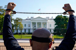 A member of the Uyghur American Association rallies in front of the White House, Thursday, Oct. 1, 2020, after marching from Capitol Hill in Washington, in support of the Uyghur Forced Labor Prevention Act which has passed the House and now will go on to the Senate. The bill prohibits some imports from Xinjiang and imposes sanctions for human rights violations.