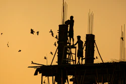 Laborers work at a building construction site in Gauhati, India, Oct. 19, 2020.