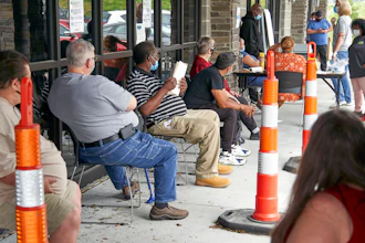 Job seekers exercise social distancing as they wait to be called into the Heartland Workforce Solutions office in Omaha, Neb.