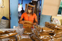 A woman wearing face mask and face shield.
