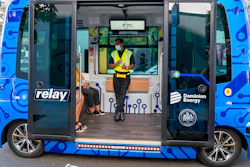 Deployment Manager Jason Peres, center, explains how Relay, an electric autonomous vehicle, works to new riders in Fairfax, Va.