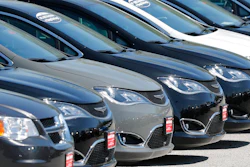 In this Wednesday, April 15, 2020 file photo, Cars are parked in an auto dealer lot in unincorporated St. Louis County, Mo. U.S. new vehicle sales fell 9.7% in the third quarter, but that's not all that bad for the auto industry. Consumers are paying record prices largely for loaded out trucks and SUVs. Discounts are down because vehicle supplies are limited. Interest rates are low.