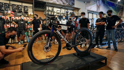 Customers wearing face masks to help curb the spread of the coronavirus look at a newly unveiled new model from the American bicycle brand at a retailed shop in Beijing on July 29, 2020. China's trade growth accelerated in September as the world's second-largest economy recovered form the coronavirus pandemic.