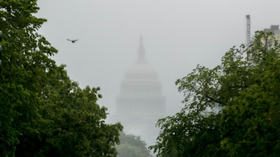 In this May 22, 2020, file photo the Dome of the U.S. Capitol Building is visible through heavy fog in Washington. New virus relief will have to wait until after the November election. Congress is past the point at which it can deliver more coronavirus aid soon, with differences between House Speaker Nancy Pelosi, Senate Republicans and President Donald Trump proving insurmountable.