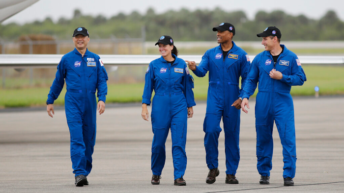 Astronaut Soichi Noguchi, of Japan, from left, NASA Astronauts Shannon Walker, Victor Glover and Michael Hopkins walk after arriving at Kennedy Space Center, Sunday, Nov. 8, 2020, in Cape Canaveral, Fla.