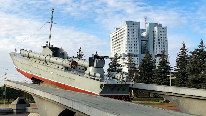 The building and the torpedo boat, the Baltic Sailors Memorial, in Kaliningrad, Russia, Thursday, Oct. 29, 2020. The hulking never-occupied building sardonically likened to a robot's head that has loomed over the city of Kaliningrad for decades is to be demolished next year, the region's governor says. The 21-story House of Soviets was left unfinished when funding ran out in 1985 amid the Soviet Union's economic struggles and later was assessed to be structurally unsound.