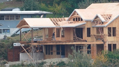 Workers at a home under construction along the waterfront in Gig Harbor, Wash., Oct. 28, 2020.