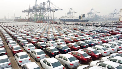 New cars wait to be transported from a port Yantai in east China's Shandong province Wednesday, Oct. 21, 2020.