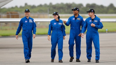 Astronaut Soichi Noguchi, of Japan, from left, NASA Astronauts Shannon Walker, Victor Glover and Michael Hopkins walk after arriving at Kennedy Space Center, Sunday, Nov. 8, 2020, in Cape Canaveral, Fla.