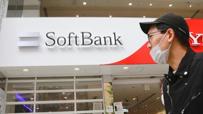 People walk by a SoftBank shop in Tokyo, Monday, Nov. 9, 2020.