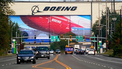 Traffic passes the Boeing airplane production plant, in Everett, Wash.