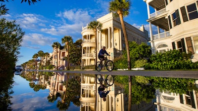 A bicyclist makes his way down East Battery as a king tide rolls into the historic Battery, Charleston, S.C., Nov. 15, 2020.