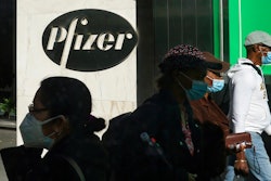 Pedestrians walk past Pfizer world headquarters in New York.
