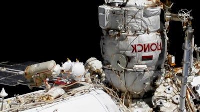 Russian astronauts Commander Sergey Ryzhikov, left, and Sergey Kud-Sverchkov outside the International Space Station, Nov. 18, 2020.