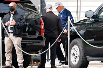 President Donald Trump, right, walks to the motorcade, Sunday, Nov. 22, 2020, as he departs the White House in Washington.