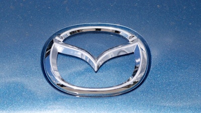 In this June 14, 2020, photograph, a Mazda company logo shines on the front of an unsold 2020 Miata at a Mazda dealership in Littleton, Colo. On Thursday, Nov. 19, Mazda beat traditional winners Lexus and Toyota to win top honors as the most dependable auto brand in Consumer Reports’ annual reliability survey. Reports surveyed organization members who own more than 300,000 vehicles from model years 2000 to 2020.