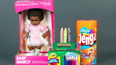 This photo, provided by the National Toy Hall of Fame, shows Baby Nancy, by Shindana Toys; Sidewalk Chalk, by Crayola; and Jenga, by Parker Brothers, left to right, that were inducted into the National Toy Hall of Fame on Thursday, Nov, 5, 2020. The honorees were chosen by a panel of experts from among 12 finalists and will be on permanent display inside The Strong National Museum of Play, in Rochester, New York.