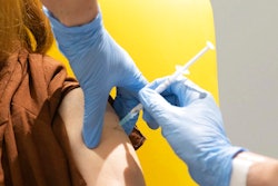 In this undated file photo issued by the University of Oxford, a volunteer is administered the coronavirus vaccine developed by AstraZeneca and Oxford University, in Oxford, England. With major COVID-19 vaccines showing high levels of protection, British officials are cautiously — and they stress cautiously — optimistic that life may start returning to normal by early April. Even before regulators have approved a single vaccine, the U.K. and countries across Europe are moving quickly to organize the distribution and delivery systems needed to inoculate millions of citizens.