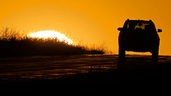 A motorist drives into the sunrise in Kansas City, Mo., Oct. 1, 2020.