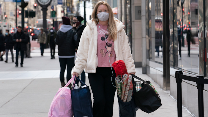 A woman carries shopping bags on Dec. 10 in New York.
