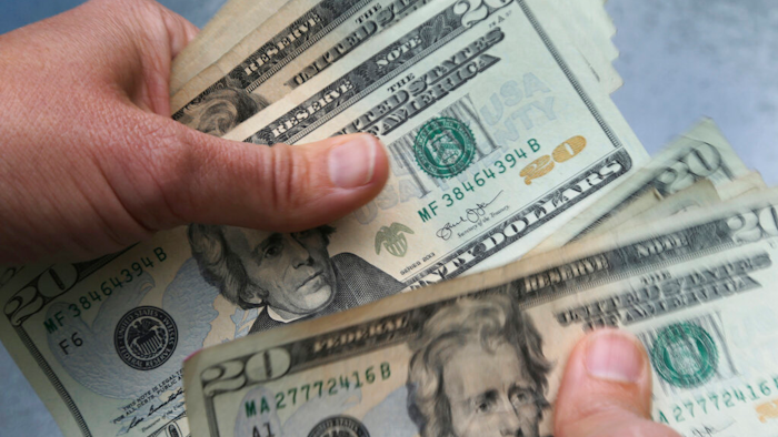 20-dollar bills are counted in North Andover, Mass.