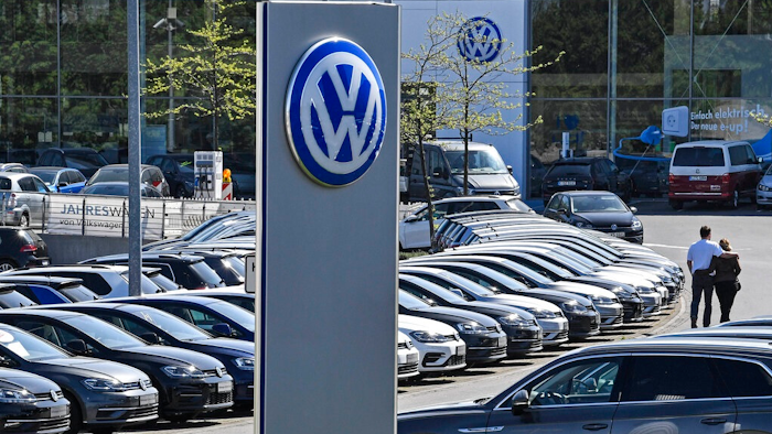 In this April 20, 2020 file photo, a Volkswagen car dealer is open in Essen, Germany. In times when a pandemic unleashes death and poverty, the concept of what is essential to keep society functioning in a lockdown is gripping Europe. What may stay open in one country may be designated as non-essential just across the border.