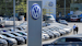 In this April 20, 2020 file photo, a Volkswagen car dealer is open in Essen, Germany. In times when a pandemic unleashes death and poverty, the concept of what is essential to keep society functioning in a lockdown is gripping Europe. What may stay open in one country may be designated as non-essential just across the border.
