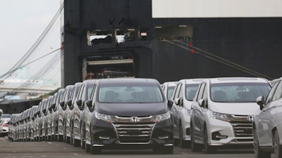 Cars wait to be exported at Yokohama port, near Tokyo.