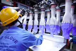 A worker inspects disposable gloves at the Top Glove factory in Shah Alam on the outskirts of Kuala Lumpur, Malaysia.