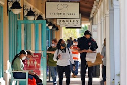 Shoppers wear protective face masks as they look for Black Friday deals at the Ellenton Premium Outlet stores.