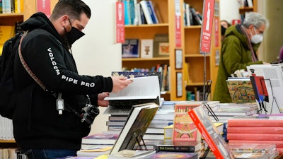 In this Nov. 28 photo, customers browse while shopping for books at the Strand Bookstore, an independent family-owned bookstore founded in 1927 in New York.