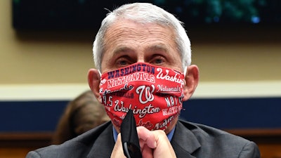 In this June 23 file photo, Director of the National Institute of Allergy and Infectious Diseases Dr. Anthony Fauci wears a face mask as he waits to testify before a House Committee on Energy and Commerce on the Trump administration's response to the COVID-19 pandemic on Capitol Hill in Washington.