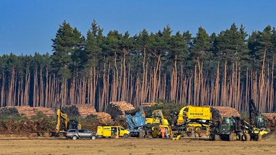 Felled trees lie on the construction site of the Tesla Gigafactory in Gruenheide near Berlin, Germany.