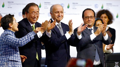 World leaders applaud after the final conference at the COP21, the U.N. conference on climate change.