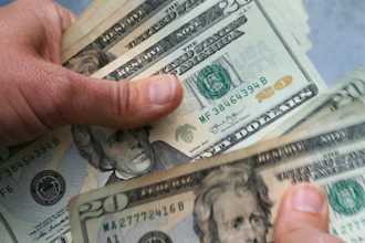 20-dollar bills are counted in North Andover, Mass.