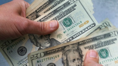 20-dollar bills are counted in North Andover, Mass.