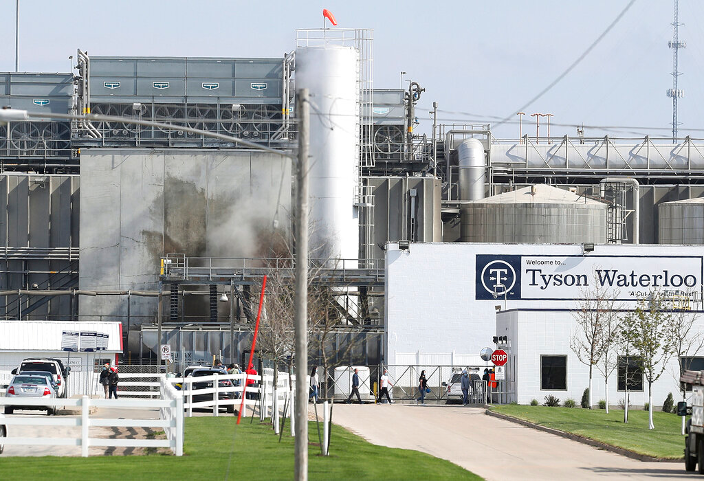 Tyson's Fresh Meat workers file in for a tour of safety measures put into place after the plant in Waterloo, Iowa, had to shut down due to a COVID-19 outbreak, May 2020.