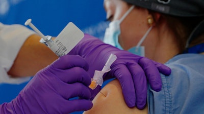 Catalina Gonzalez-Marques, an emergency medical physician, receives the Pfizer-BioNTech coronavirus vaccine.