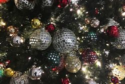 Ornaments hang on a Christmas tree on display in New York.