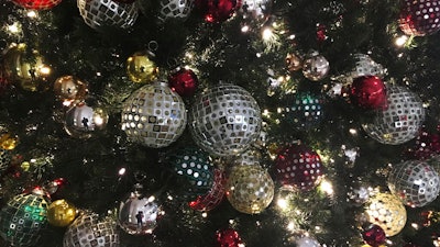 Ornaments hang on a Christmas tree on display in New York.