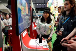 Visitors to the Pax East conference play the Nintendo Switch video game Animal Crossing, Feb. 27, 2020, in Boston.