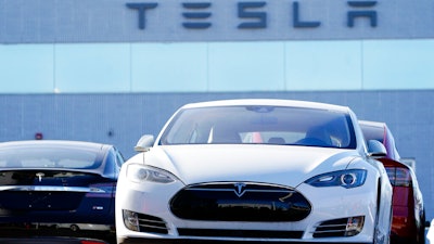 An unsold 2021 S70 sedan sits at a Tesla dealership.